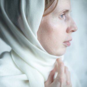 Portrait of Anya Baro in white scarf with soft natural light