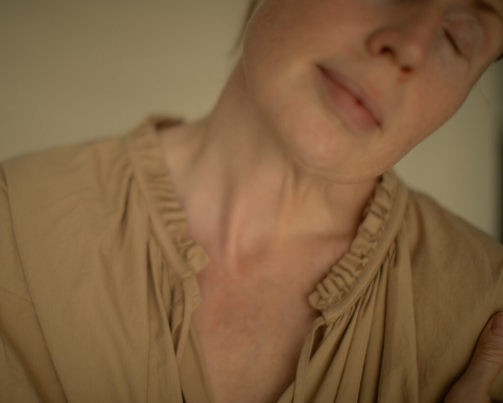 Woman with closed eyes resting in a state of comfort and emotional safety