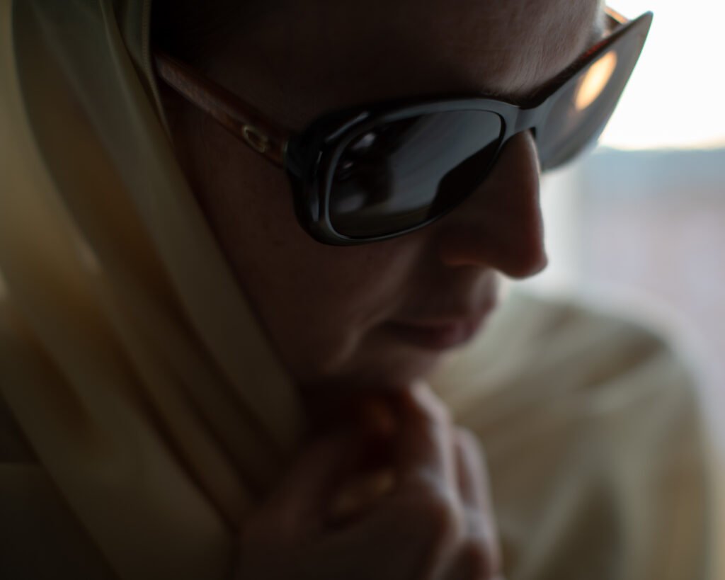 Cinematic portrait with black sunglasses in warm natural light