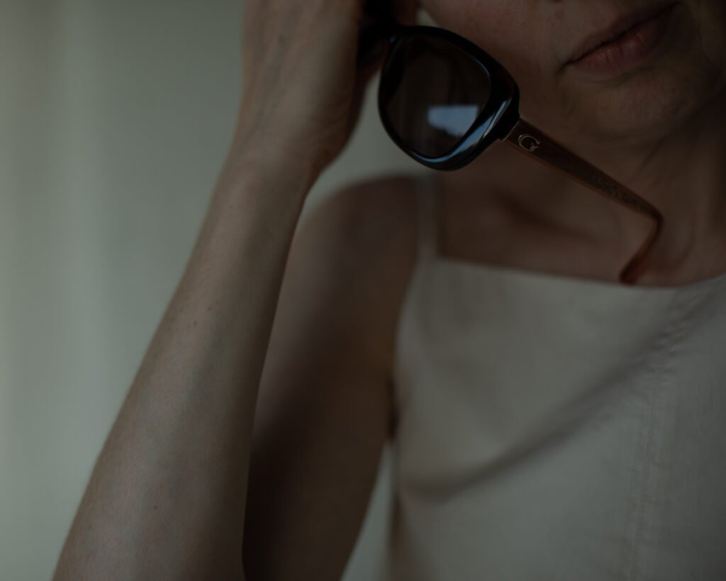 Minimal portrait with luxury sunglasses and soft shadows