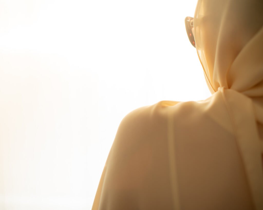 Minimal cinematic luxury portrait with cream fabric and soft glowing window light