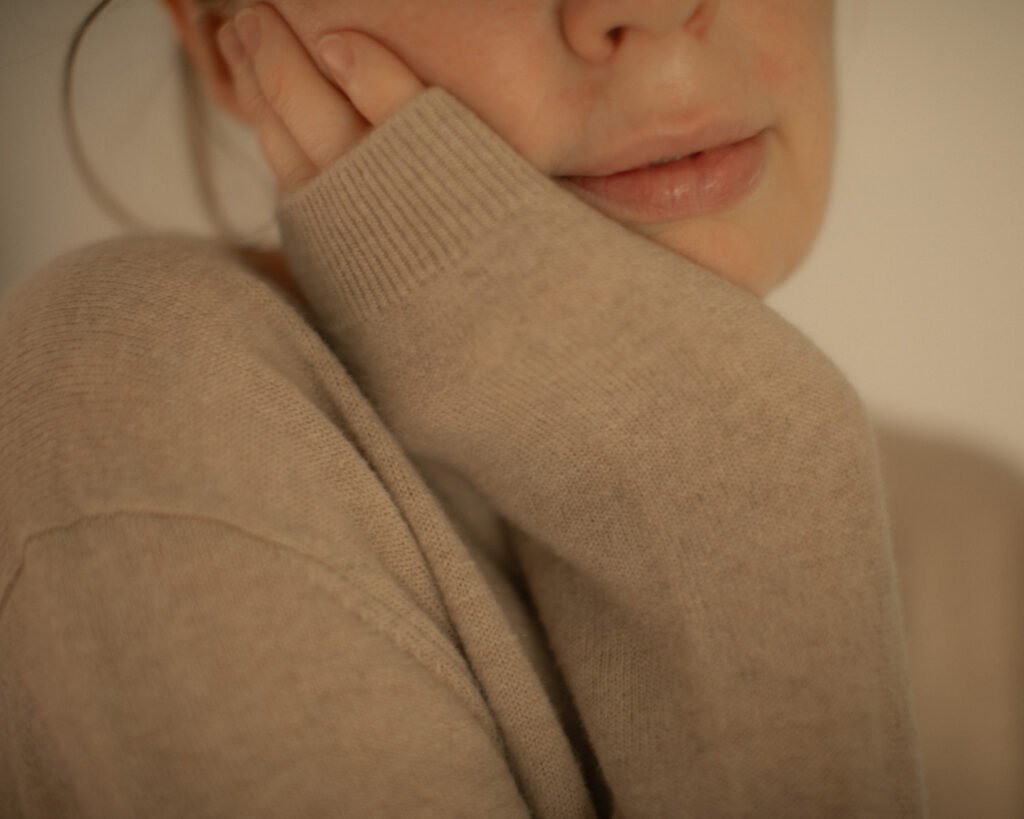 Close-up knitwear texture in soft luxury editorial photography by Anya Baro