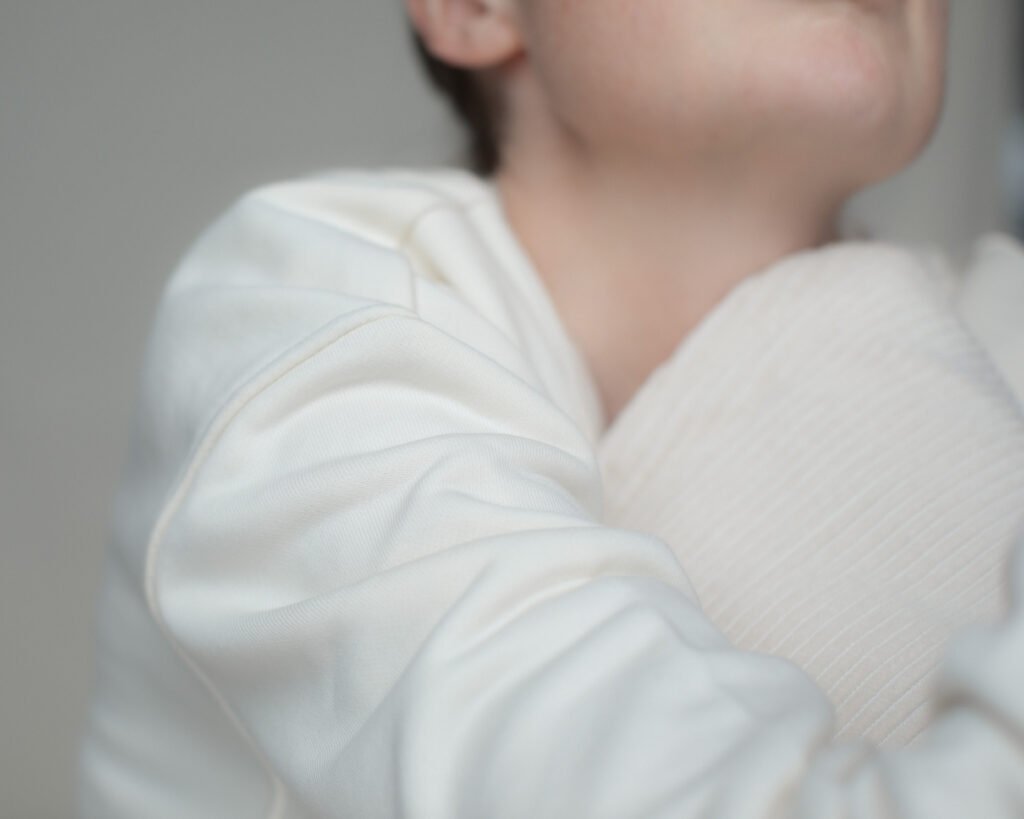 Minimal portrait exploring comfort and emotional rest.