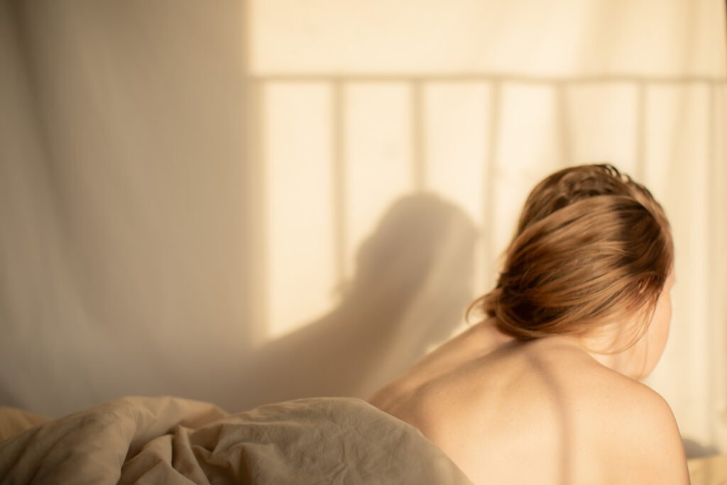 Woman enjoying a quiet moment in soft natural light, Living Well series by Anya Baro
